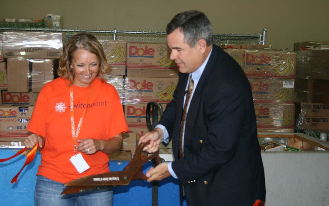 Mayor Pike and Carol Hollowell cut the ribbon on the new food pantry, Photo by George Scott