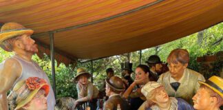 A New Chapter of Independent Spirit "Were You Invited?” (2014), Edition 1/8, is a cast bronze and aluminum installation by the Seward Johnson Atelier, standing 26 ft × 13 ft in the Rats Woodlands at Grounds For Sculpture. Photo courtesy Grounds For Sculpture. Learn more about its setting at the Grounds For Sculpture website